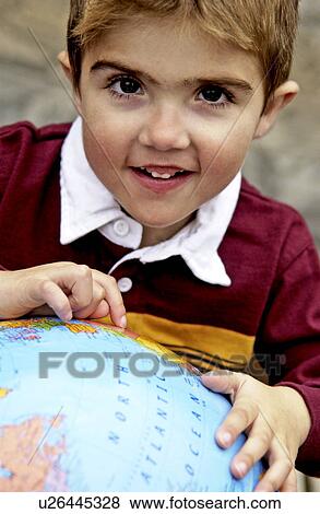 Stock Photo - Boy looking at globe. Fotosearch
