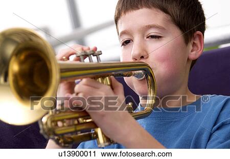 Stock Image - Boy playing trumpet. Fotosearch