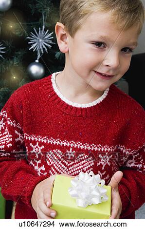 Picture - Child holding Christmas gift. Fotosearch