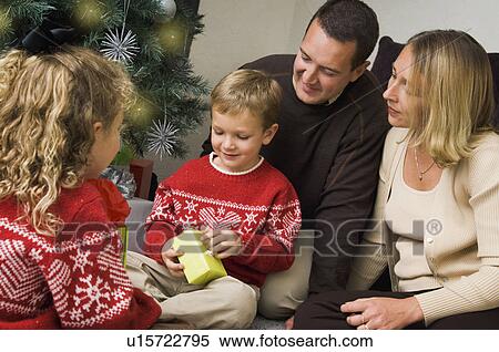 Stock Photography - Family opening Christmas gifts. Fotosearch