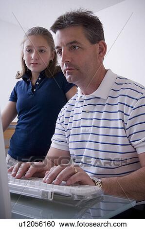 Stock Image - Father and daughter at computer. Fotosearch
