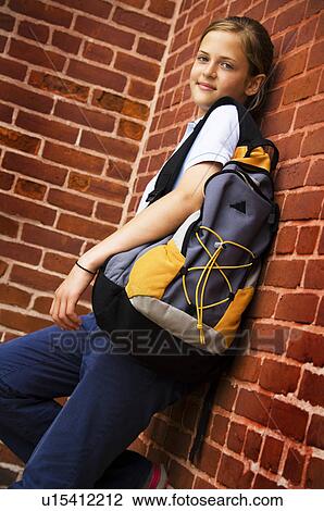 Girl in school uniform wearing a backpack View Large Photo Image Stock Image - Girl in school uniform wearing a backpack. Fotosearch