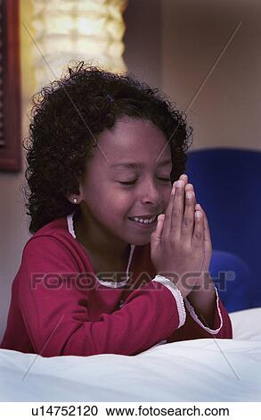 Stock Image - Girl praying. Fotosearch