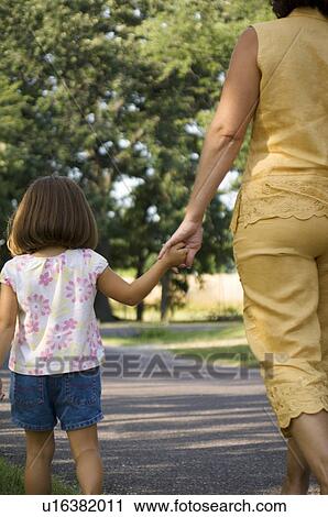 Stock Image - Grandma and granddaughter taking a walk. Fotosearch