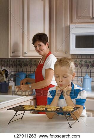 Grandma and grandson baking cookies View Large Photo Image Stock Image - Grandma and grandson baking cookies. Fotosearch