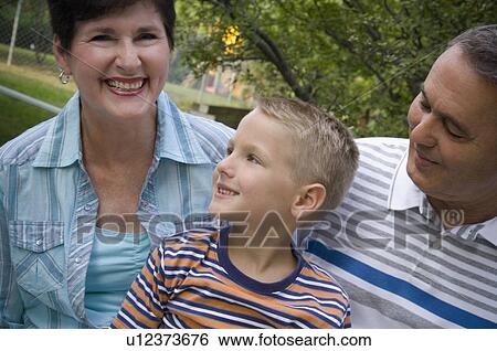 Stock Photograph - Grandson with grandparents. Fotosearch