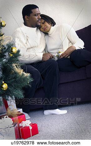 African American couple relaxing on couch View Large Photo Image Stock Photo - African American couple relaxing on couch. Fotosearch