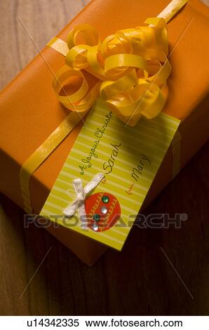 Stock Photography - Christmas gift with tag. Fotosearch