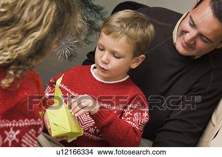 Picture - Family opening Christmas gifts. Fotosearch