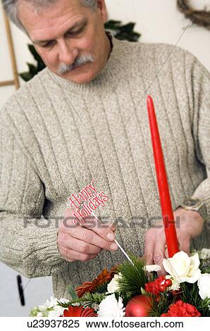 Stock Photography - Florist preparing Christmas floral arrangement. Fotosearch