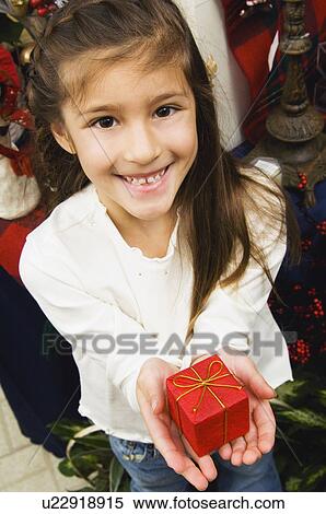 Girl holding gift View Large Photo Image Stock Photography - Girl holding gift. Fotosearch