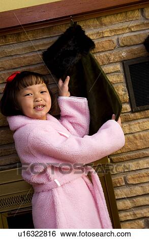 Stock Photograph - Girl with Christmas stocking. Fotosearch