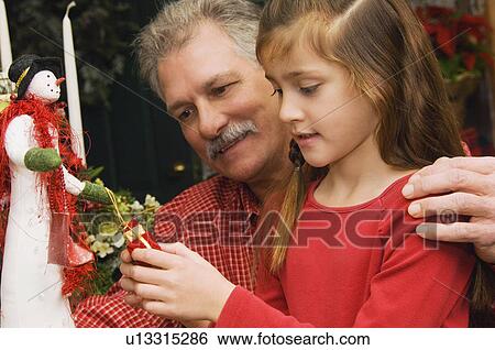 Stock Photograph - Grandpa and granddaughter christmas shopping. Fotosearch