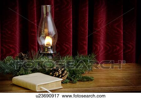 Oil lamp and Bible in church setting View Large Photo Image Stock Photo - Oil lamp and Bible in church setting. Fotosearch