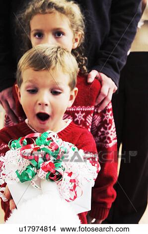 Picture - Boy getting a gift from Santa. Fotosearch