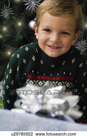 Stock Image - Boy with Christmas gift. Fotosearch