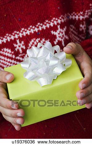 Child holding Christmas gift View Large Photo Image Stock Photograph - Child holding Christmas gift. Fotosearch