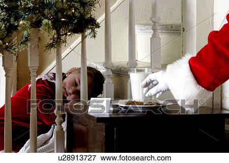 Stock Photo - Child sleeping during Santas visit. Fotosearch