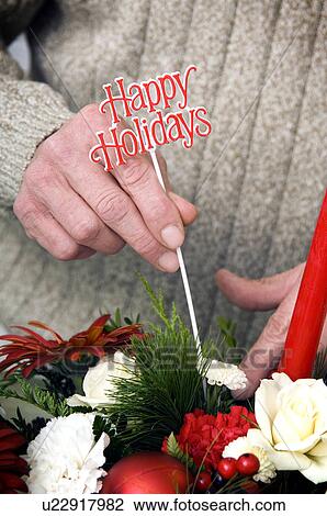 Florist preparing Christmas floral arrangement View Large Photo Image Stock Image - Florist preparing Christmas floral arrangement. Fotosearch