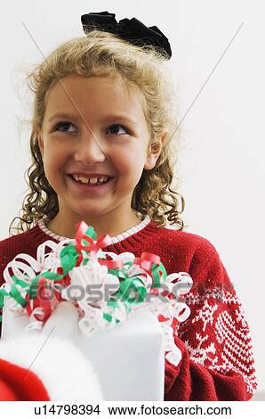 Picture - Girl getting gift from Santa. Fotosearch