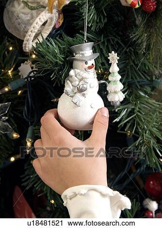Girl hanging ornament View Large Photo Image Stock Image - Girl hanging ornament. Fotosearch