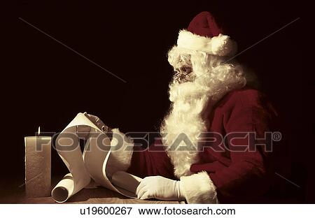 Stock Photo - Santa making a list. Fotosearch
