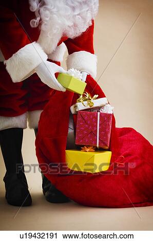 Stock Image - Santa with bag of gifts. Fotosearch