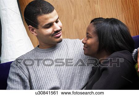 Stock Image - African American couple cuddling. Fotosearch