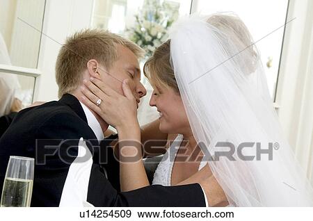 Stock Photo - Bride and groom kissing. Fotosearch