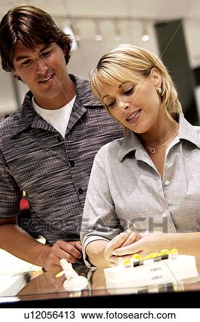 Couple looking at rings View Large Photo Image Stock Image - Couple looking at rings. Fotosearch