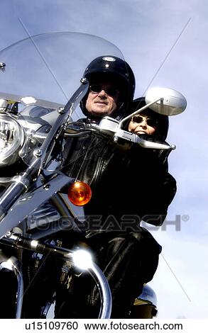 Stock Image - Couple on motorcycle. Fotosearch