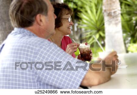 Stock Photograph - Senior couple at outdoor bar. Fotosearch