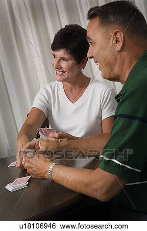 Stock Photograph - Senior couple playing cards. Fotosearch