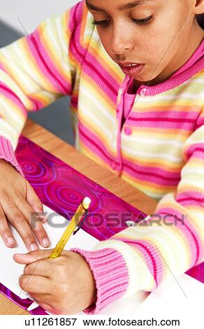 Stock Photo - African American girl doing homework. Fotosearch