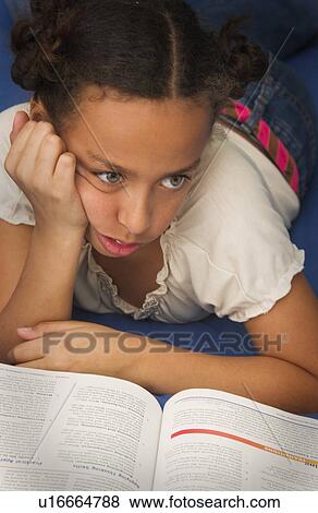 Stock Photo - African American girl doing homework. Fotosearch