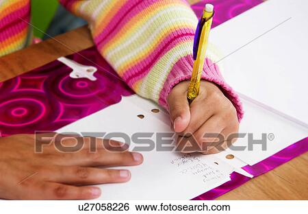 Stock Photograph - African American girl doing homework. Fotosearch