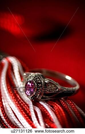 Stock Photograph - Class ring graduation cap and tassel. Fotosearch
