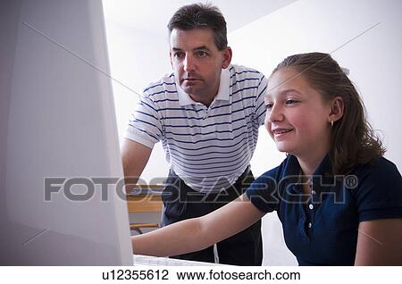 Stock Image - Father and daughter at computer. Fotosearch