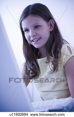 Picture - Girl at computer. Fotosearch