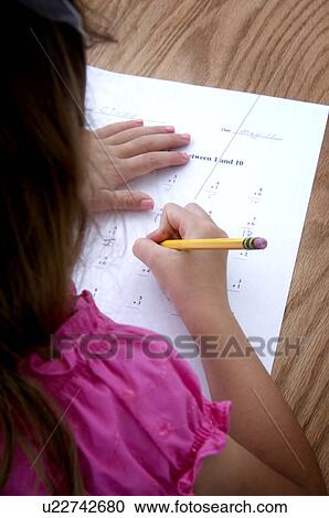 Stock Image - Girl doing homework. Fotosearch