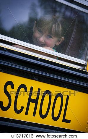 Stock Image - Girl on school bus. Fotosearch