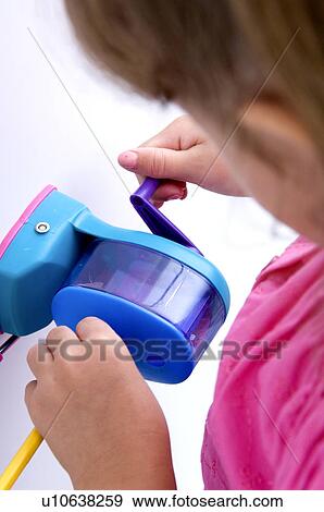 Stock Photo - Girl sharpening pencil. Fotosearch