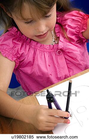 Stock Photography - Girl using compass. Fotosearch