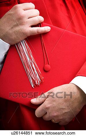 Graduate holding cap View Large Photo Image Stock Image - Graduate holding cap. Fotosearch