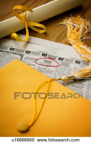 Graduation cap diploma and tassel setting on help wanted ads View Large Photo Image Stock Image - Graduation cap diploma and tassel setting on help wanted ads. Fotosearch