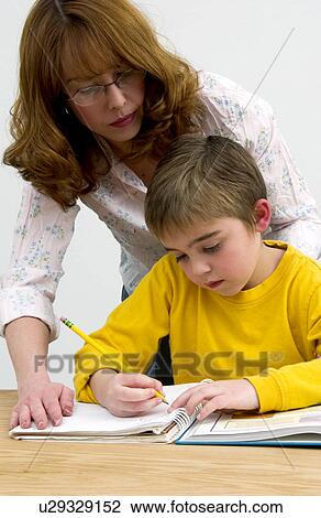 Mother or teacher helping boy with homework View Large Photo Image Stock Image - Mother or teacher helping boy with homework. Fotosearch