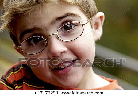 Stock Image - Portrait of a boy with eyeglasses. Fotosearch