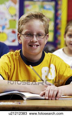 Stock Image - Student in classroom. Fotosearch