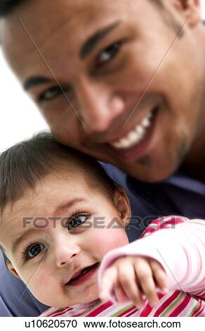 Stock Image - African American father holding daughter. Fotosearch