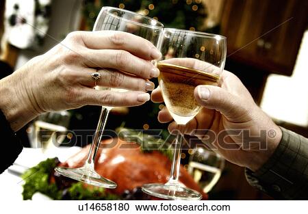 Couple toasting at holiday dinner View Large Photo Image Stock Image - Couple toasting at holiday dinner. Fotosearch